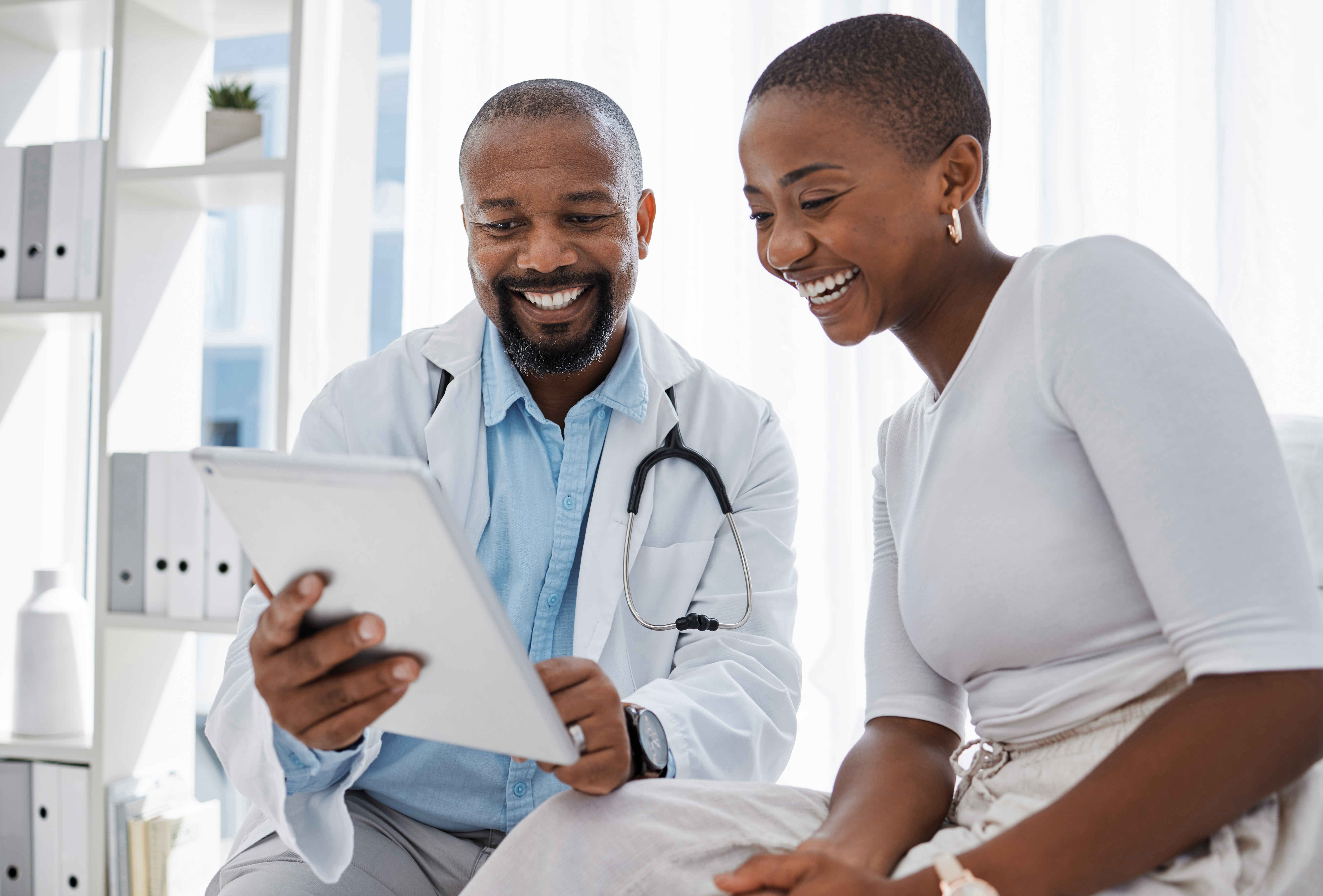 Healthcare worker reviewing medical records with patient